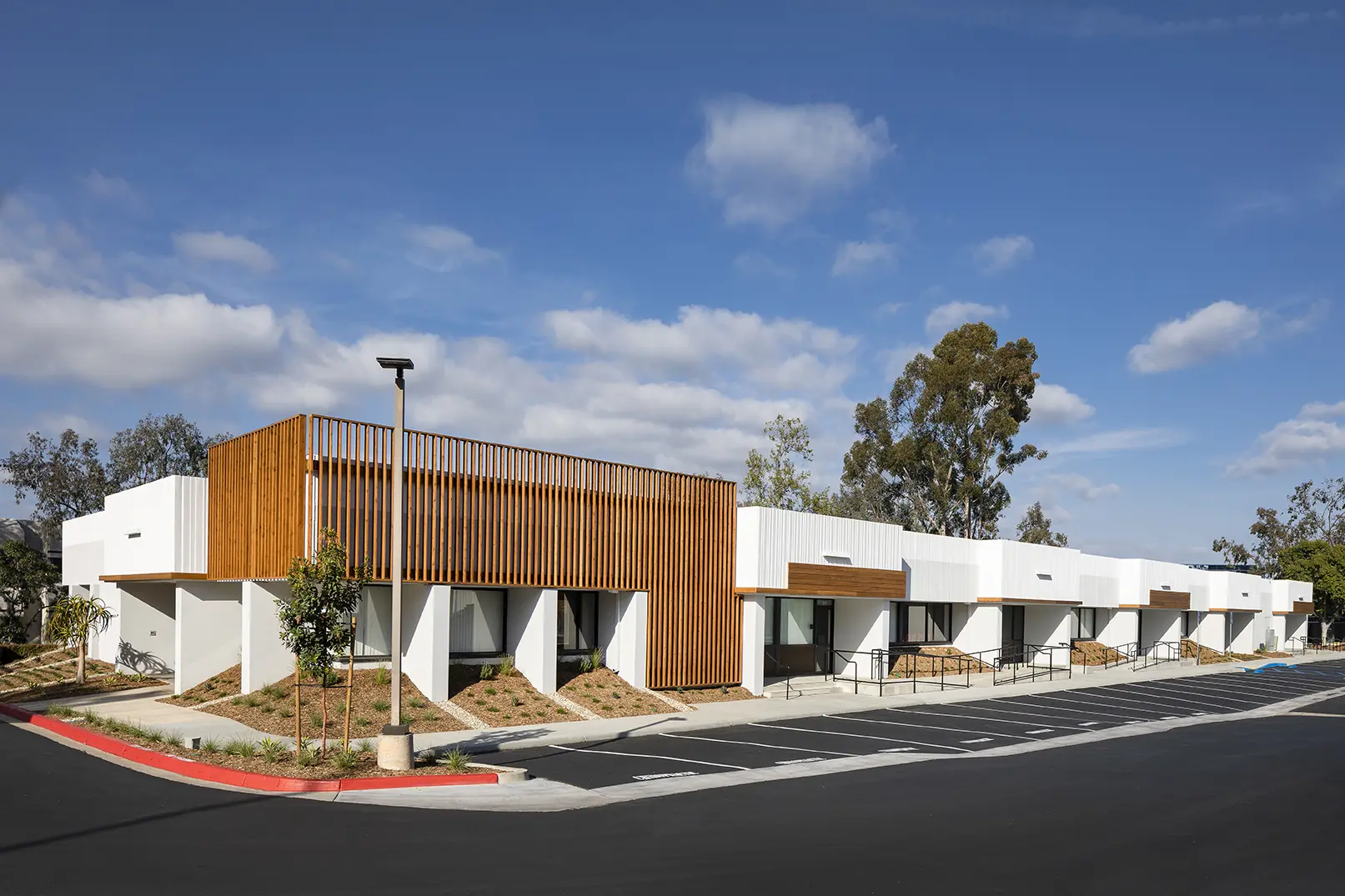 A building with wood and concrete on the side.