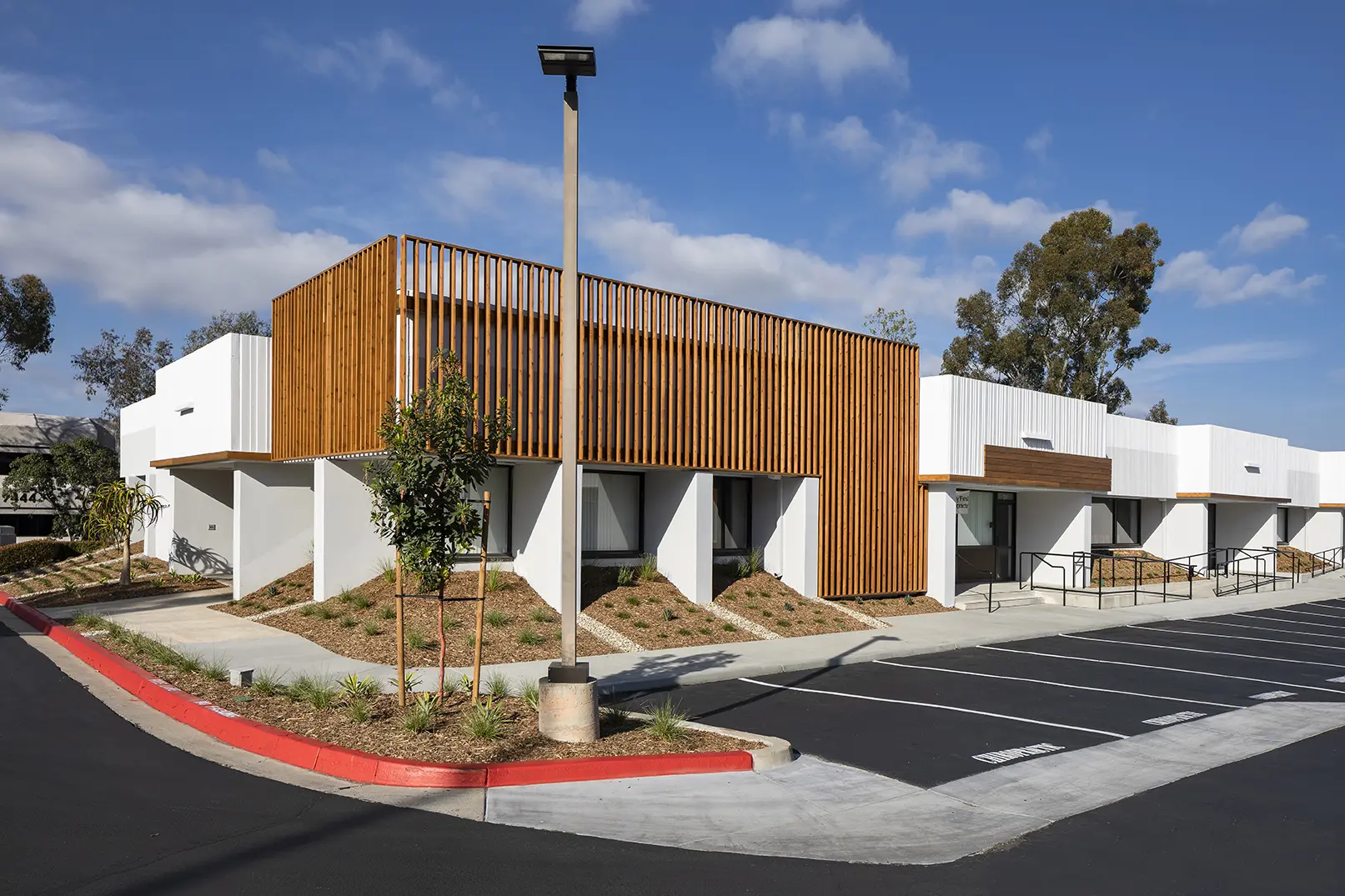 A building with wood and concrete on the side.