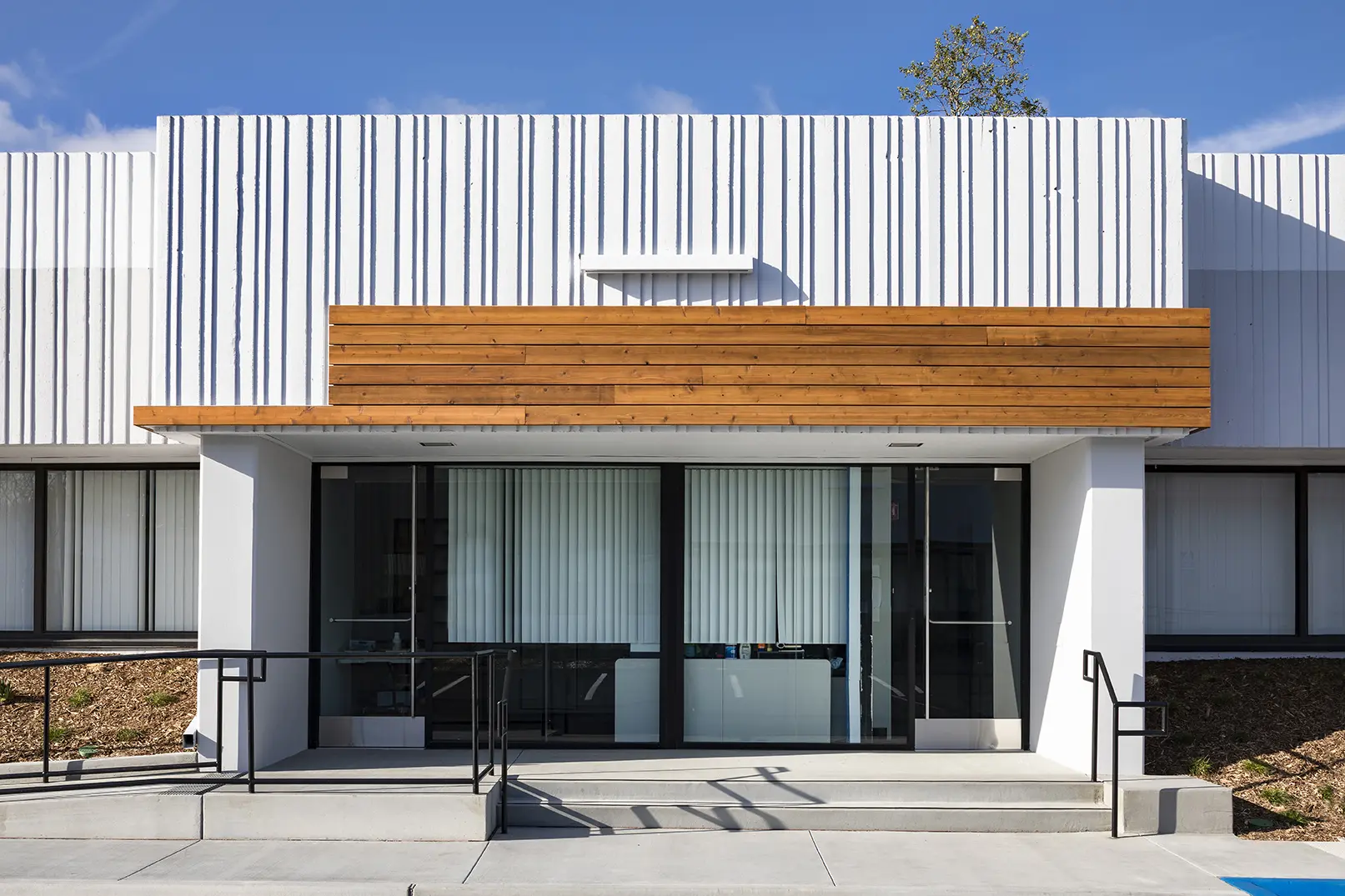 A building with two glass doors and a wooden roof.